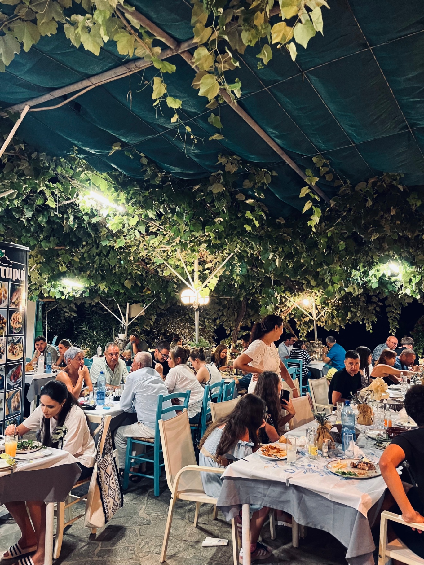 Busy outdoor dining atmosphere at night